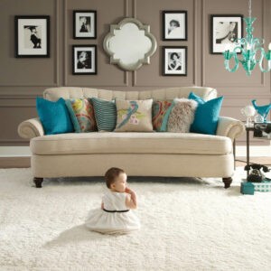 Cute baby sitting on carpet floor | Specialty Flooring