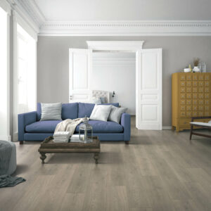 Living room laminate flooring with blue sofa | Specialty Flooring
